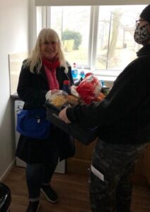 Person being given a care kit