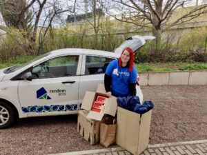 Krissi at Random Acts delivers a donation with the Random Acts car