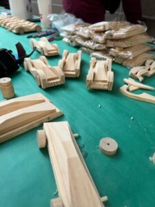 wooden toy cars on a table, waiting to be painted